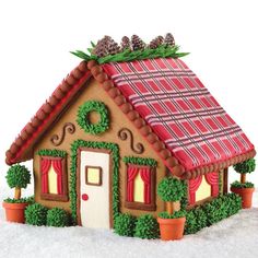 a gingerbread house with decorations on the roof