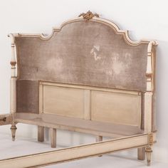 an old fashioned bed frame with no headboard or foot board, in white and beige