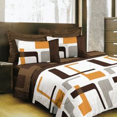 a bed with brown and white comforters in a bedroom