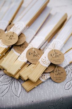 several wooden sticks with tags on them sitting on a table