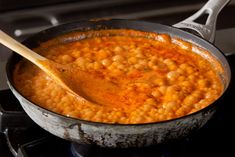 a pot filled with beans on top of a stove