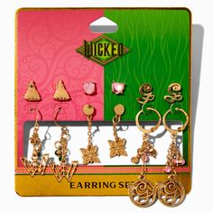 an assortment of earrings in a card with the word luck written on it and four charms attached to each earring