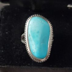 The Images Depict A Sterling Silver Ring Featuring A Turquoise Gemstone. Here Is A Detailed Description Of The Ring: General Description - Ring Type: Sterling Silver Turquoise Ring - Gemstone: Turquoise - Gemstone Shape: Freeform, Irregular Shape - Gemstone Size: Approximately 2.5 Cm In Length Design Details - Setting: The Turquoise Stone Is Set In A Bezel Setting With A Twisted Rope Design Border. - Band: The Band Of The Ring Is Split Into Two Parts, Each With A Twisted Rope Design, Giving It A Blue Turquoise Sterling Silver Ring Stamped 925, Blue Turquoise Ring In Sterling Silver Stamped 925, Blue Turquoise Ring In Sterling Silver, Blue Turquoise Ring With Large Stone In Sterling Silver, Classic Blue Turquoise Ring Stamped 925, Untreated Sterling Silver Turquoise Ring, Blue Hallmarked Turquoise Ring, Fine Jewelry Sterling Silver Oval Turquoise Ring, Handmade Classic Sterling Silver Turquoise Ring