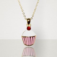 This adorable little cupcake necklace is just as sweet as you little girl. Pink and white enamel with a bright red cherry jewel atop. Outlined in a gold border with a gold chain. What a lovely piece of accessory to compliment any outfit. Suitable for children age 3 and over. Chain length 71/2 in. Cupcake Necklace, Baby Bible, Earth Baby, Cupcake Charms, Hand Sanitizer Holder, Red Cherry, Gold Border, Mini Wallet