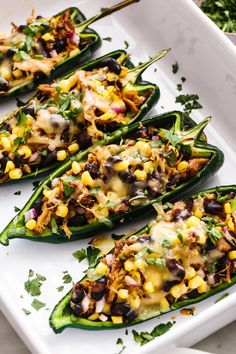 several green peppers stuffed with mexican food and garnish