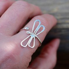 These Dragonfly Rings are so beautiful on....Two styles to choose from... either the dragonfly that on a sterling silver band that has "landed" on our finger or the other style is like a Dragonfly "hug" that wraps around the finger (and is slightly adjustable if needed!) First photo: Wrap around dragonfly (slightly adjustable) Second photo: Landed on finger dragonfly Third photo: shows the two Dragonfly style of rings side by side. I handcrafted these dragonfly Rings from solid sterling silver. Handmade Silver Adjustable Butterfly Ring, Adjustable Silver Butterfly Ring Minimalist Style, Unique Nickel-free Butterfly Ring For Gift, Minimalist Adjustable Silver Butterfly Ring, Handmade Adjustable Butterfly Ring For Wedding, Handmade Adjustable Butterfly Wedding Ring, Make Spoon Rings, Jewelry Tutorials Free, Finger Style