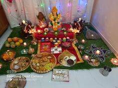 an assortment of food is displayed on the floor in front of a wall with lights