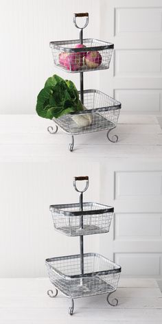 three tiered metal baskets with vegetables in them on top of a white countertop