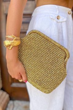 Add a touch of glamour to your evening look with this stunning metallic gold raffia clutch bag. Handcrafted with care using traditional crochet techniques, this pouch bag exudes luxury and sophistication, making it a perfect accessory for special occasions. The shimmering metallic gold raffia material of this clutch bag catches the light, creating a dazzling effect that is sure to turn heads. Its crochet pattern adds a delicate and intricate texture to the design, showcasing the craftsmanship and attention to detail. Designed for the summer season, this raffia luxury handbag is a perfect choice for weddings, parties, or other formal events. Its gold tone and chic style make it a versatile accessory that can complement a wide range of outfits, from cocktail dresses to evening gowns. ✔️ Suit Crochet Pouch Bag, Raffia Clutch, Crochet Clutch Bags, Diy Clutch, Clutch Bag Wedding, Crochet Pouch, Crochet Clutch, Gold Bag, Bag Summer