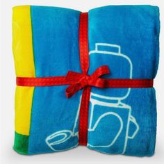 two towels wrapped in blue and yellow with a red ribbon