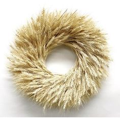 a close up of a wreath made out of dried grass on a white background with clippings