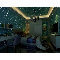 a bedroom with stars and moon decals on the ceiling