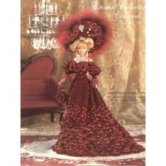 a barbie doll wearing a red dress and hat with feathers on it's head