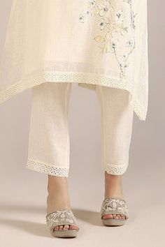 Off-white kurta with camelia flower print and crochet lace embroidered cutwork border. Paired with pant. - Aza Fashions Off White Floral Print Sets For Summer, Off White Floral Print Sets For Spring, Off-white Floral Print Sets For Summer, White Feminine Sets For Spring, Spring Off White Floral Print Sets, Elegant Floral Embellished Sets For Summer, Elegant Floral Embellished Sets For Spring, Elegant Floral Sets For Summer, Traditional Floral Print Bottoms For Spring