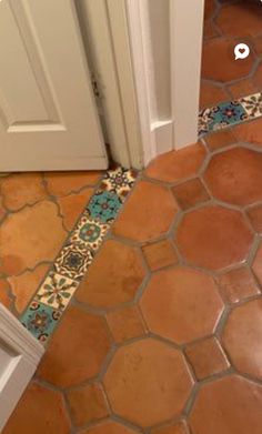 a bathroom with a door and tile floor