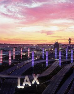 an aerial view of the lax international airport at sunset, with lights lit up in pink and purple