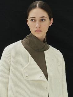 This is REMPLACEMENT’s unique-looking cardigan. With all buttons fastened, it can be worn as a top, making it versatile for both standalone and layered styles. The use of wool material provides excellent insulation, ensuring warmth even in cold winters. The hidden mini buttons (loop processing) at the neck center allow you to secure the neckline.- Ideal for daily wear- Can be styled with various bottoms for different looks- Front buttons are detachable Wool Cardigan With Button Cuffs For Layering, Winter Merino Wool Outerwear With Button Closure, Merino Wool Button-up Outerwear With Button Closure, Wool Knit Outerwear For Layering, Merino Wool Sweater With Buttons For Work, Merino Wool Outerwear With Buttons For Work, Merino Wool Cardigan For Work, Fall Merino Wool Sweater Coat With Buttons, Fall Merino Wool Outerwear With Buttons