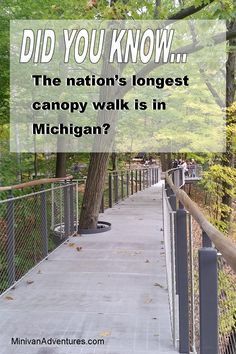 a walkway that has a sign on it saying, did you know the nation's largest canopy walk is in michigan?