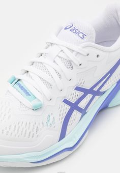 the white and blue tennis shoe is on a white surface with light blue trimmings