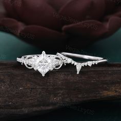 a close up view of a diamond ring on a piece of wood