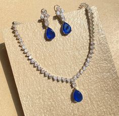 Sapphire Jewelry Set features a stunning blue diamond necklace adorned with cubic zirconia. Inspired by Sabyasachi, this contemporary statement piece is perfect for weddings. Its elegant design makes it a beautiful and memorable gift for her on her special day. *𝐏𝐑𝐎𝐃𝐔𝐂𝐓 𝐃𝐄𝐓𝐀𝐈𝐋* * 𝐌𝐚𝐭𝐞𝐫𝐢𝐚𝐥: Brass * 𝐏𝐥𝐚𝐭𝐢𝐧𝐠: White Rhodium Plated * 𝐒𝐭𝐨𝐧𝐞: AAA-quality CZ Diamond & Sapphire. *𝐃𝐈𝐌𝐄𝐍𝐒𝐈𝐎𝐍𝐒* *𝐍𝐞𝐜𝐤𝐥𝐚𝐜𝐞* * 𝐖𝐞𝐢𝐠𝐡𝐭: 40 gm * 𝐃𝐞𝐬𝐢𝐠𝐧 𝐋𝐞𝐧𝐠𝐭𝐡: 3 Sapphire And Diamond Necklace, Blue Sapphire Necklace, Designer Replica, Jewelry Fashion Trends, Jewellery Ideas, Hairdo For Long Hair