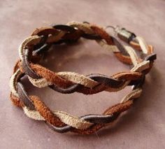 two braided bracelets sitting on top of a table