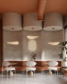 the interior of a modern restaurant with round lights and white chairs in front of concrete walls