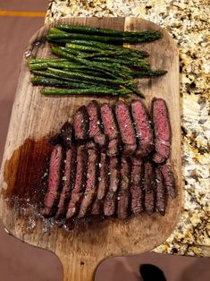 steak and asparagus on a cutting board ready to be cooked in the oven