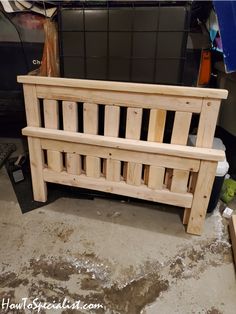 a wooden bed frame sitting on top of a dirty floor