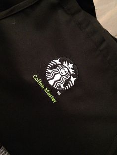 the starbucks logo is on the back of a black jacket