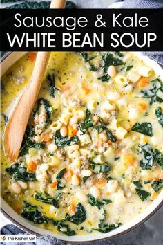 A bowl of sausage and kale white bean soup with a wooden spoon. The soup includes pieces of sausage, kale leaves, white beans, diced carrots, and pasta in a creamy broth. The top of the image has text: Sausage & Kale White Bean Soup.