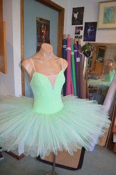 a mannequin wearing a light green tutu