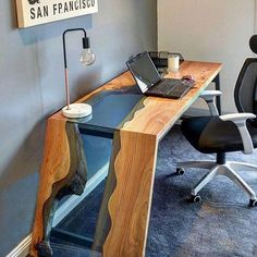 a desk with a laptop on it in an office