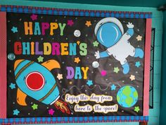 a bulletin board that says happy children's day with an image of a rocket ship