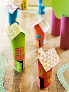 colorful paper houses sitting on top of a wooden table