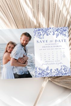 save the date card with an image of a couple on it next to a fan