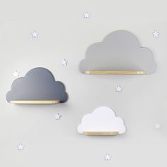 three clouds and stars are on the wall next to each other, with gold trimmings