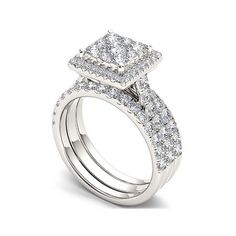 an engagement ring set with two square shaped diamonds on the side and one round diamond at the top