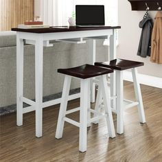 two stools sit under a table with a laptop on it