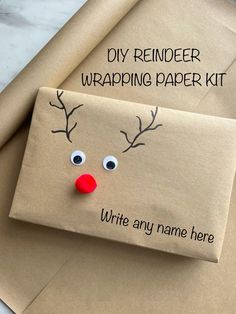 an envelope with a reindeer's face on it and the words, diy reindeer wrapping paper kit write any name here