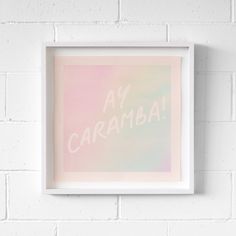 a white frame hanging on a brick wall with the words, ar carambai