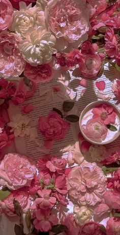 pink and white flowers on top of a book