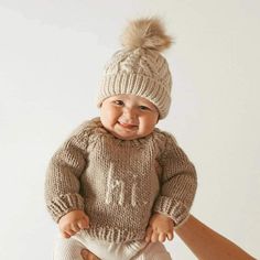 Stay warm this winter season with this adorable neutral baby beanie & be sure to add the HI sweater Neutral Sweater, Neutral Sweaters, Pom Pom Beanie Hat, Cozy Pullover, Knit Beanie Hat, Knit Cap, Polyester Yarn