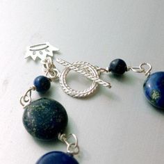 This lapis lazuli bracelet handcrafted by Jewelry By Carmal is made of navy blue lapis lazuli rondelle and disk gemstones, sterling silver: crown charm, toggle and findings. This bracelet measures up to 7 3/4 inches in length. View more beaded bracelets: http://www.etsy.com/shop/jewelrybycarmal?section_id=8002918 The ancient Romans used lapis as an aphrodisiac. Lapis lazuli is said to help stimulate emotional, mental, and physical purity and clarity. The ancient Egyptians used lapis for protecti Handmade Adjustable Sapphire Jewelry, Handmade Adjustable Lapis Lazuli Bracelets, Handmade Blue Sterling Silver Beaded Bracelets, Sapphire Lapis Lazuli Beaded Bracelet With Natural Stones, Handmade Bohemian Lapis Lazuli Bracelets, Blue Sodalite Round Beaded Jewelry, Beaded Lapis Lazuli Bracelet, Lapis Lazuli Bracelet With Natural Stones, Artisan Blue Bracelets With Gemstone Beads