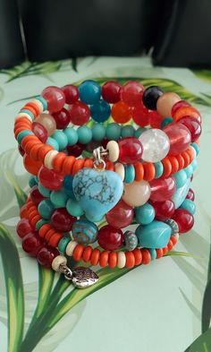 Size : One size fits most Bracelet: 5.5 loops                  4-14mm Beautiful bold,vibrant color/bead mix of Red,Turquoise, Oranges, cream. A tropical island vibe Bohemian Bracelets With Heart Beads For Festival, Bohemian Beaded Bracelets With Heart Beads, Hippie Style Multicolor Round Bead Bracelets, Hippie Style Multicolor Round Beaded Bracelets, Bohemian Red Beaded Bracelets With Heart Beads, Red Hippie Beaded Bracelets For Gift, Unique Multicolor Bracelets With 8mm Beads, Colorful Handmade Bohemian Stretch Bracelet, Bohemian Multicolor Stretch Bracelet For Jewelry Making