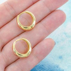 "SEVENTEEN TAPERED HUGGIE EARRINGS Named for its 17 mm diameter, these tapered huggies make a lovely addition to any outfit! These beautifully polished hoops are great for your casual OOTD. Sold as a pair. Description: -18K gold plated brass Approximate Measurements: -Huggie Diameter: 0.67\" (17 mm) -Earring Weight: 2.1 grams Want to ship your order directly to a friend? We've got you covered! Let us know it's a gift by clicking on the \"This order is a gift\" box and add a gift message for free Classic Brass Small Hoop Huggie Earrings, Classic Brass Hoop Huggie Earrings, Gold-tone Tarnish-resistant Small Hoop Huggie Earrings, Elegant Gold-tone Huggie Earrings In Brass, Gold-tone Small Hoop Brass Huggie Earrings, Crescent Earrings, Sleeper Earrings, Letter Necklace, Simple Earrings