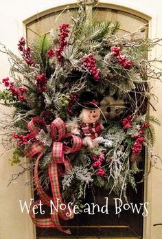 a wreath on the front door decorated for christmas