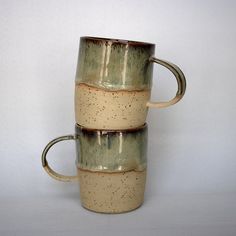 three coffee mugs stacked on top of each other