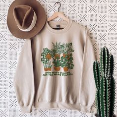 This plant lover sweatshirt is a perfect plant sweatshirt for any plant lovers out there. The botanical print sweater is a unisex sweatshirt that is also a perfect hippie sweatshirt and aesthetic sweatshirt. Get it as a gift for her or gift for him as these plant inspired sweatshirts are unisex and will make a great statement that you are a plant lover. Available in Small, Medium, Large, XL, 2XL, 3XL, 4XL and 5XL ✨ 50% cotton, 50% polyester ✨ Medium-heavy fabric ✨ Loose fit ✨ Sewn-in label ✨ Run Fall Cotton Sweatshirt With Plant Print, Fall Casual Sweatshirt With Plant Print, Cotton Sweatshirt With Plants Print For Fall, Casual Plants Print Sweatshirt For Fall, Botanical Style Cotton Sweatshirt For Fall, Botanical Long Sleeve Tops With Plant Print, Casual Crew Neck Sweatshirt With Plant Print, Plant Clothes, Plant Sweatshirt