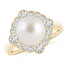 a white pearl and diamond ring on a gold plated band, with the center surrounded by small round diamonds